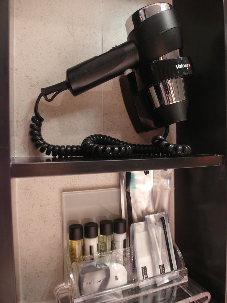 Well-equipped bathroom with hair dryer and amenities