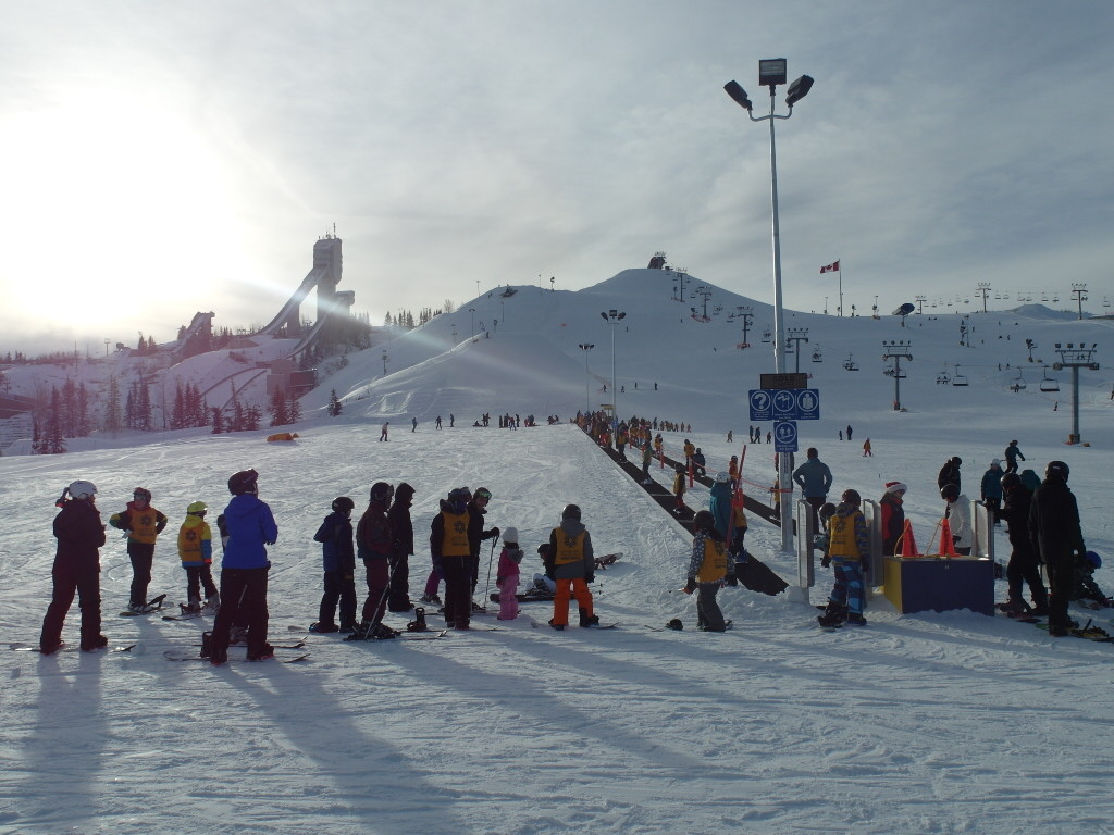 Many many young kids learning how to ski and snowboard.