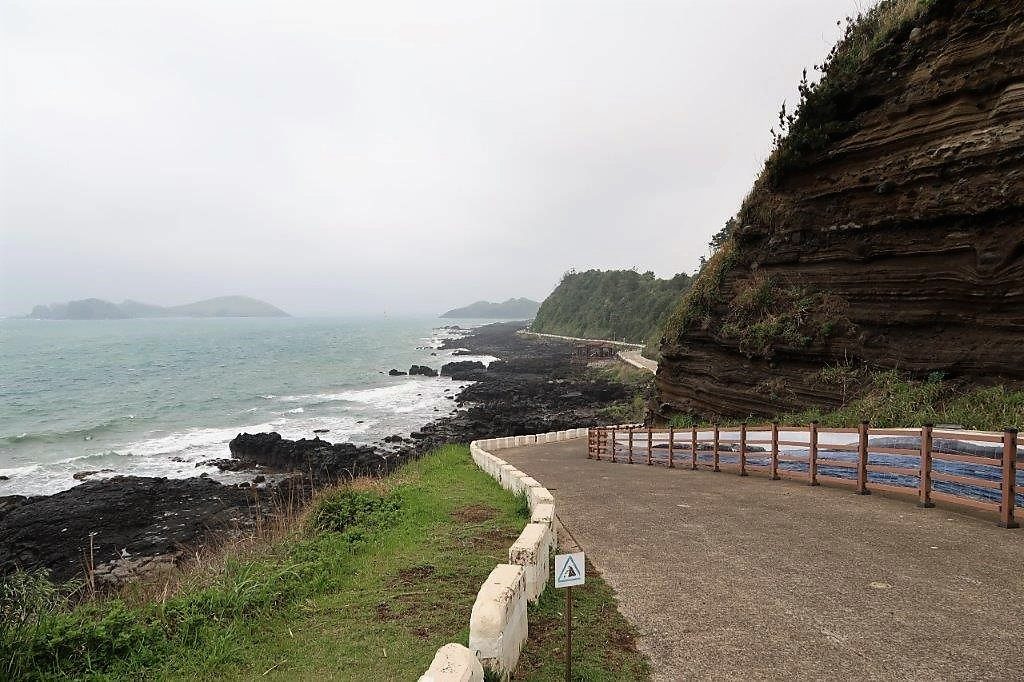 Walking along coastline of Jeju Suwolbong Peak