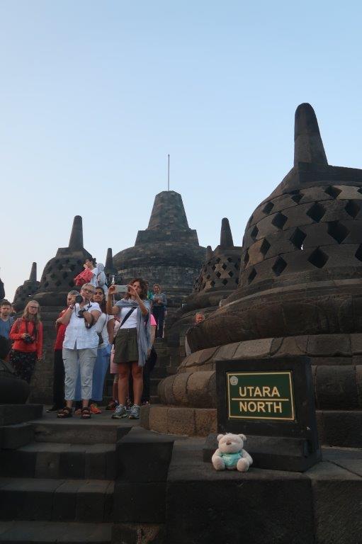 Tourists taking photos from top of the stairs downwards at Borobudur