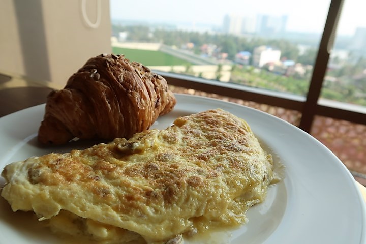 Omelette and croissants with views from Grand Club Lounge Hyatt Kochi