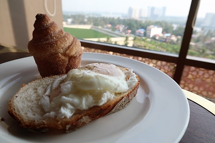 Poached eggs and sourdough bread with views from Grand Club Lounge Hyatt Kochi