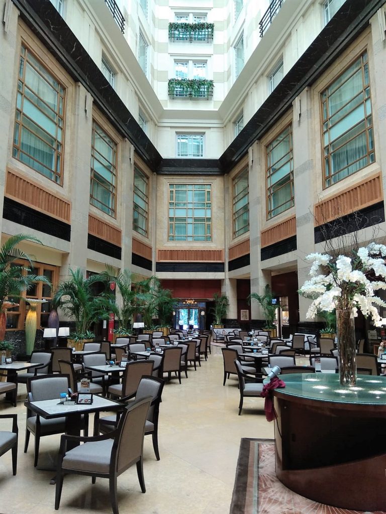 The Courtyard Restaurant in the sunlit atrium lobby of the Fullerton Hotel Singapore