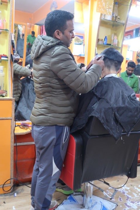 Tom getting a hair cut at Leh Market Barber - Probably his highest altitude hair cut