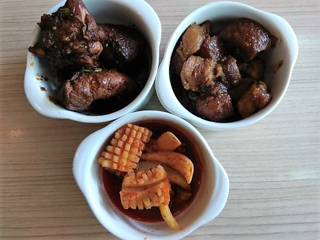 Clockwise from top: Ayam Buah Keluak, braised pork in fermented soy bean sauce and Cuttlefish at Spice Brasserie Peranakan lunch buffet