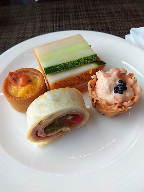 Savoury treats from left (clockwise): Petite Quiche, Sandwich, Lobster Cornet and Smoked Duck Wrap
