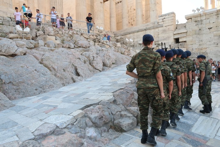Guards marching past the Propylaia (Acropolis Athens) as visitors watched on