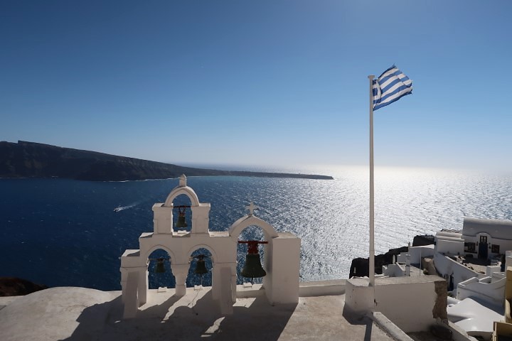 Another iconic picture in Oia with Greek flag in the fore ground and shiny blue waters in the background
