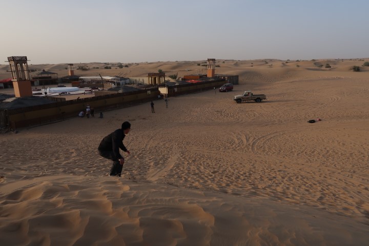 Tom doing some sand boarding in the deserts of Dubai