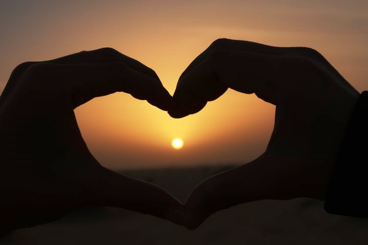 Sunset in Dubai desert framed with a heart