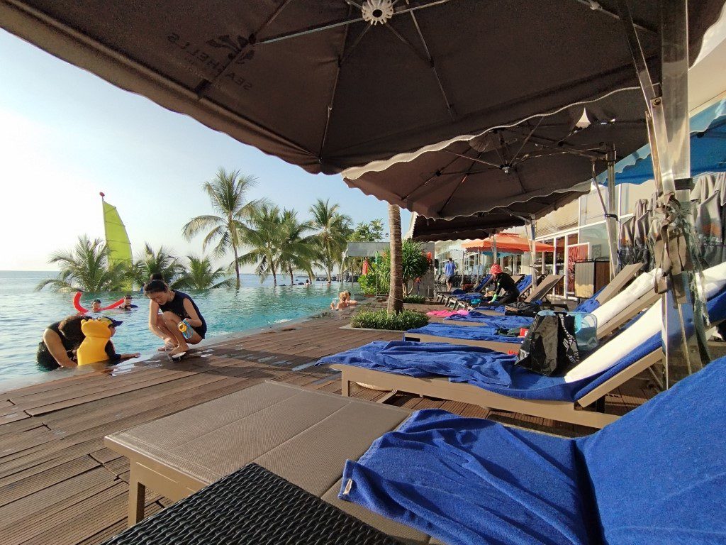 Most of the deck chairs at the swimming pool taken up at Seashells Phu Quoc Hotel & Spa