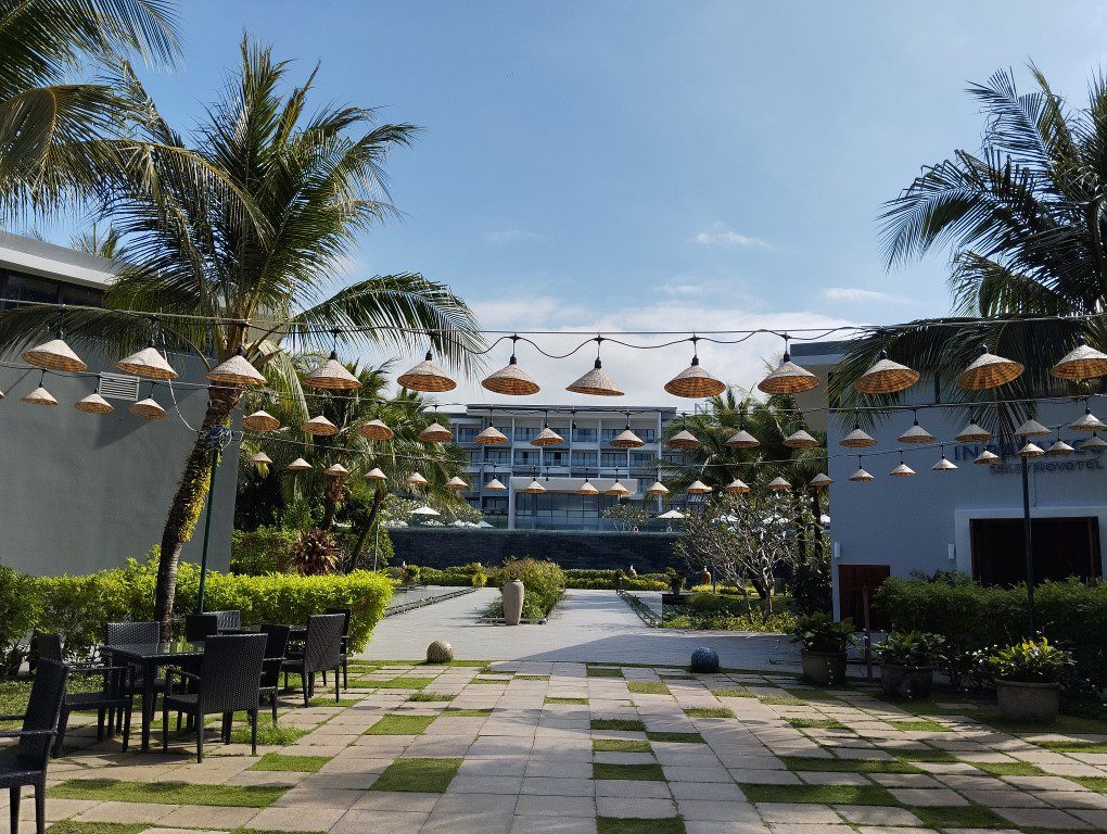 Walking past the Non La hat decorations and Koi ponds before reaching beachfront swimming pool of Novotel Phu Quoc Resort