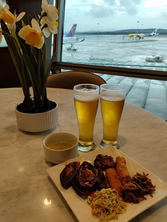 Chilling out at an area next to the buffet with views of the runway from Travel Club Lounge KLIA Terminal 1