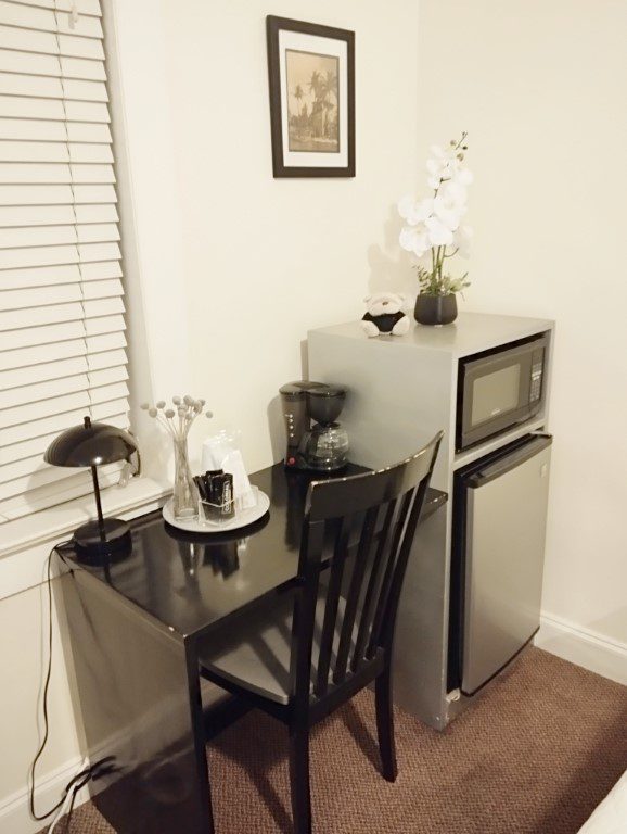 Inside our room of Hotel Ponce De Leon Miami - Table , Microwave Oven and Refrigerator