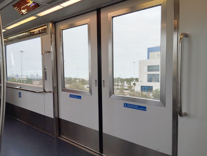 Taking the MIA Mover from Miami Airport Car Rental Center to Miami Airport - Inside MIA Mover with Miami City in the distance